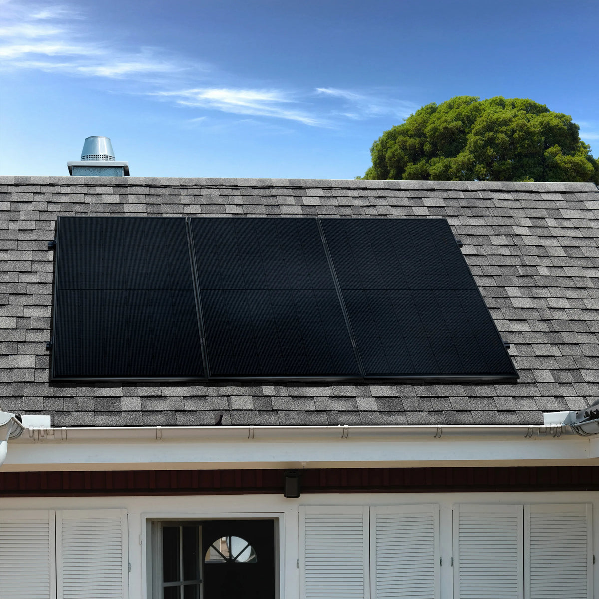 3 schwarze Solarmodule installiert auf einem Bitumendach mit grauen Schindeln